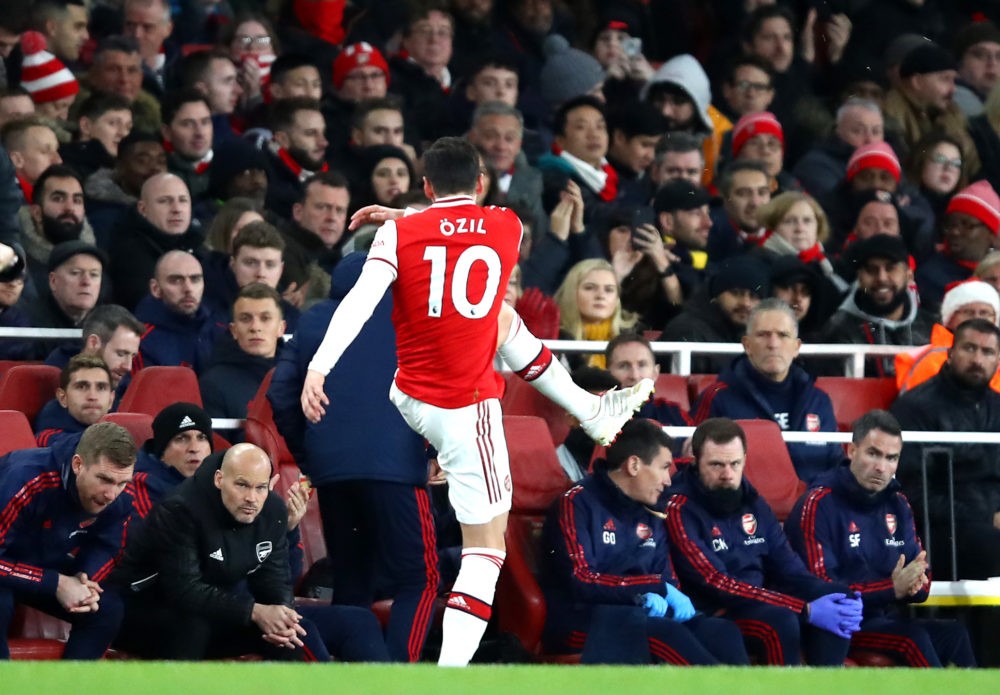 LONDON, ENGLAND - DECEMBER 15: Mesut Ozil of Arsenal kicks a water bottle as he is subbed as Interim Manager of Arsenal, Freddie Ljungberg looks on during the Premier League match between Arsenal FC and Manchester City at Emirates Stadium on December 15, 2019 in London, United Kingdom. (Photo by Julian Finney/Getty Images)