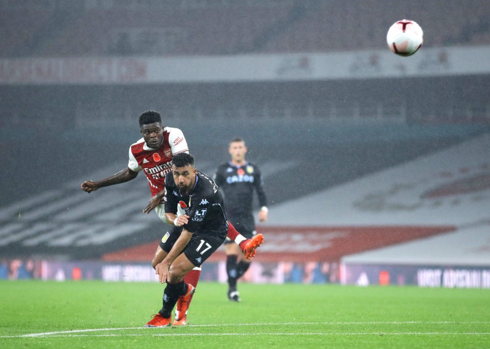 LONDON, ENGLAND - NOVEMBER 08: Thomas Partey of Arsenal shoots under pressure from Trezeguet of Aston Villa during the Premier League match between...