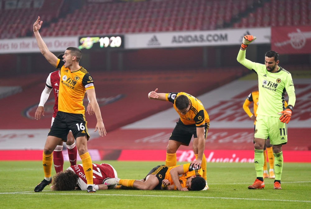 LONDON, ENGLAND - NOVEMBER 29: David Luiz of Arsenal and Raul Jimenez of Wolverhampton Wanderers lie injured after a collision during the Premier L...