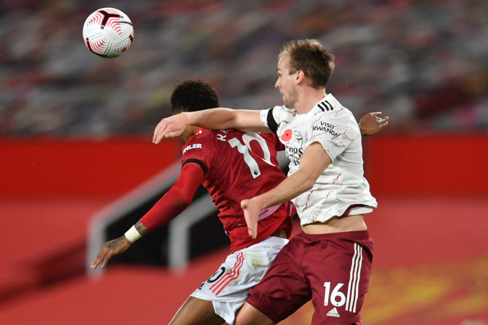 Manchester United's English striker Marcus Rashford (L) is hurt in this challenge with Arsenal's English defender Rob Holding (R) on November 1, 20...