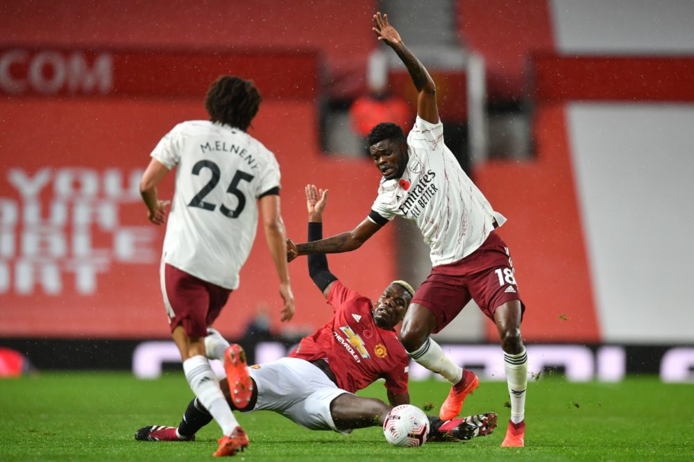 Arsenal's Ghanaian midfielder Thomas Partey (R) vies with Manchester United's French midfielder Paul Pogba (C) during the English Premier League football match between Manchester United and Arsenal at Old Trafford in Manchester, north west England, on November 1, 2020. (Photo by Paul ELLIS / POOL / AFP)