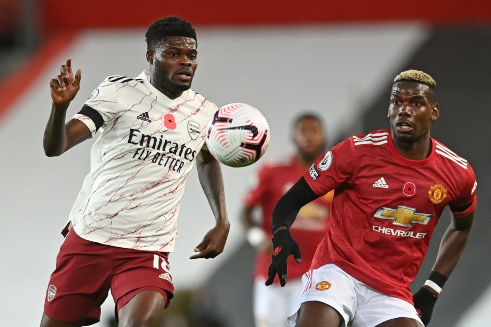 Arsenal's Ghanaian midfielder Thomas Partey (L) vies with Manchester United's French midfielder Paul Pogba (R) during the English Premier League fo...