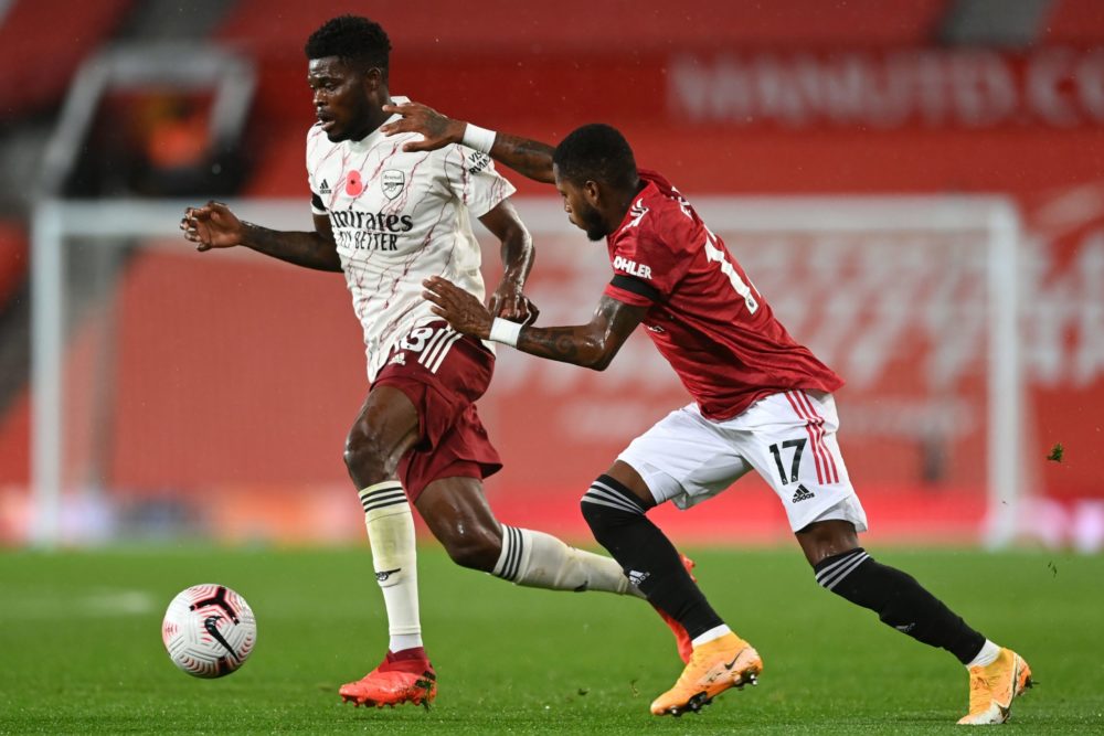 Arsenal's Ghanaian midfielder Thomas Partey (L) vies with Manchester United's Brazilian midfielder Fred (R) during the English Premier League footb...