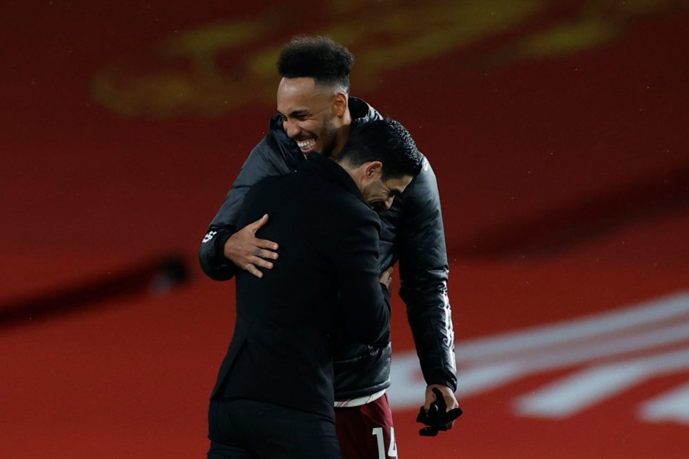 Arsenal's Gabonese striker Pierre-Emerick Aubameyang (L) embraces Arsenal's Spanish manager Mikel Arteta (R) at the end of the English Premier Leag...