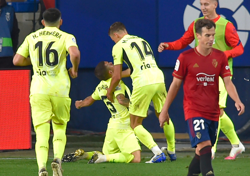 Atletico Madrid's Uruguayan midfielder Lucas Torreira (2L) celebrates after scoring a goal during the Spanish League football match between Osasuna...