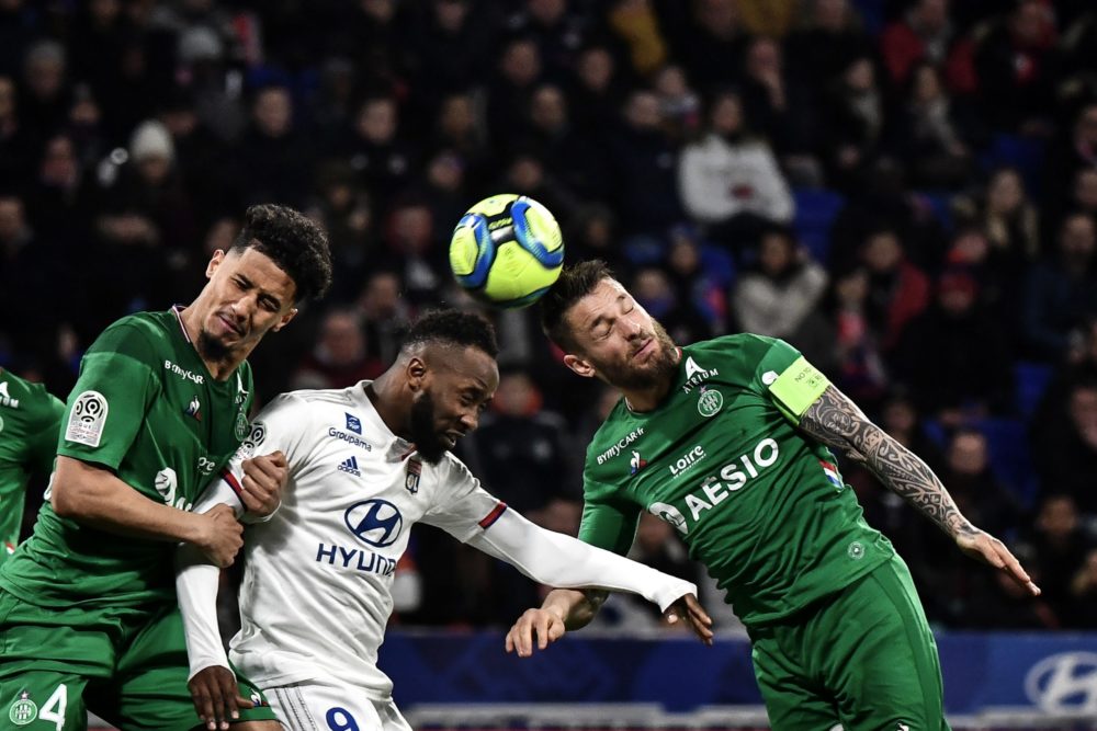 Lyon's French forward Moussa Dembele (C) fights for the ball with Saint-Etienne's French defender William Saliba (L) and Saint-Etienne's French def...