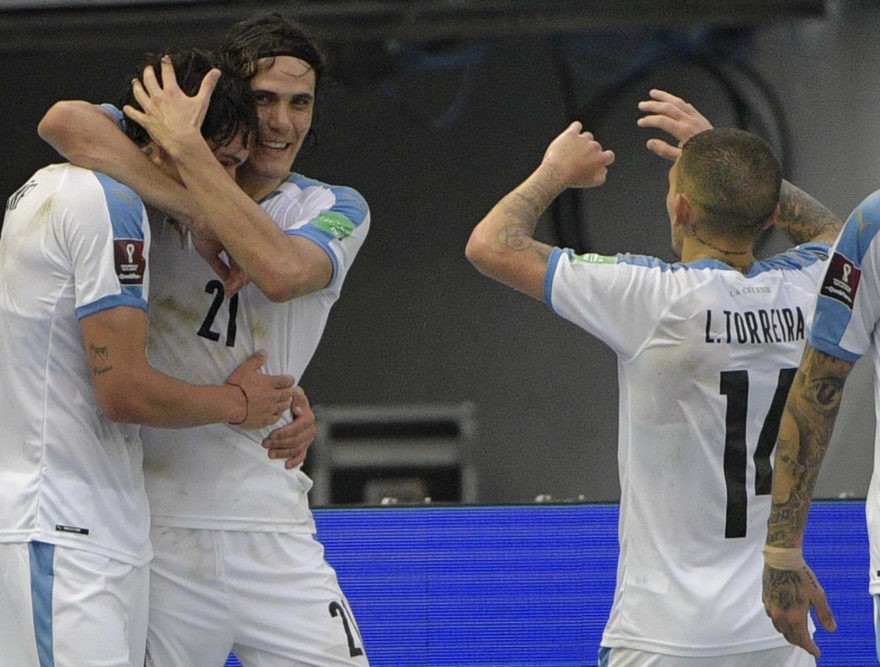 Uruguay's Darwin Nunez (L) celebrates with teammates Uruguay's Edinson Cavani and Lucas Torreira (R) after scoring against Colombia during their cl...