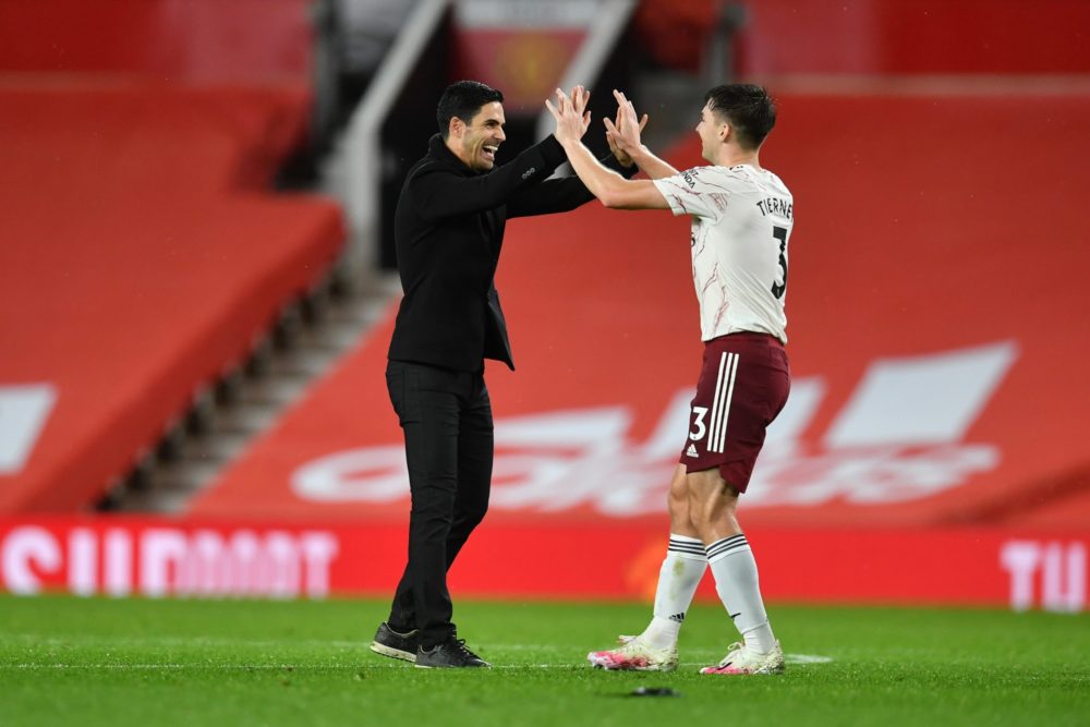 Mikel Arteta laughs about Kieran Tierney 2 MANCHESTER, ENGLAND - NOVEMBER 01: Mikel Arteta, Manager of Arsenal and Kieran Tierney of Arsenal celebrate following their team's victory in the Premier League match between Manchester United and Arsenal at Old Trafford on November 01, 2020 in Manchester, England. Sporting stadiums around the UK remain under strict restrictions due to the Coronavirus Pandemic as Government social distancing laws prohibit fans inside venues resulting in games being played behind closed doors. (Photo by Paul Ellis - Pool/Getty Images)