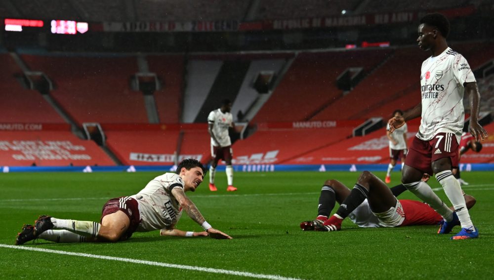 MANCHESTER, ENGLAND - NOVEMBER 01: Hector Bellerin of Arsenal goes down injured after being fouled by Paul Pogba of Manchester United, leading to Arsenal being awarded a penalty during the Premier League match between Manchester United and Arsenal at Old Trafford on November 01, 2020 in Manchester, England. Sporting stadiums around the UK remain under strict restrictions due to the Coronavirus Pandemic as Government social distancing laws prohibit fans inside venues resulting in games being played behind closed doors. (Photo by Paul Ellis - Pool/Getty Images)