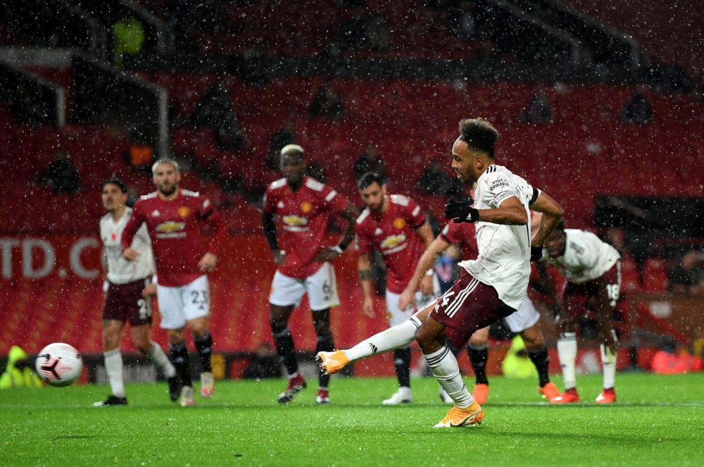 MANCHESTER, ENGLAND - NOVEMBER 01: Pierre-Emerick Aubameyang celebrates after scores from the penalty spot during the Premier League match between Manchester United and Arsenal at Old Trafford on November 01, 2020 in Manchester, England. Sporting stadiums around the UK remain under strict restrictions due to the Coronavirus Pandemic as Government social distancing laws prohibit fans inside venues resulting in games being played behind closed doors. (Photo by Shaun Botterill/Getty Images)