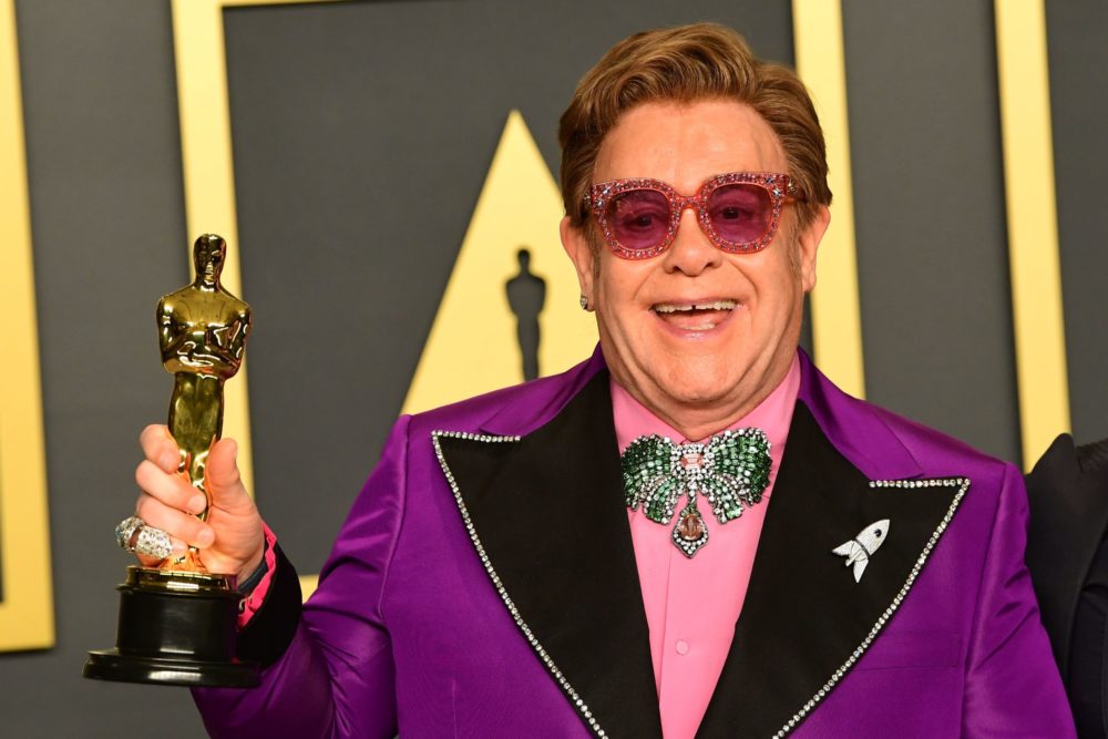 British singer-songwriter Elton John poses in the press room with the Oscar for Best Original Song for "(I'm Gonna) Love Me Again, 'Rocketman'" dur...