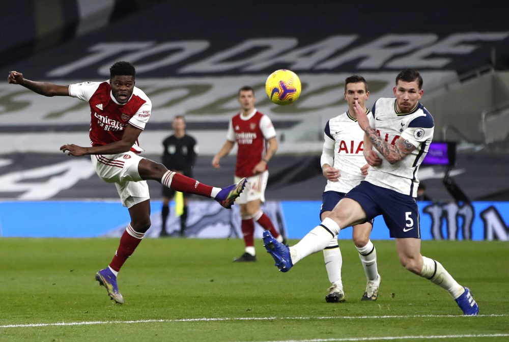 Tottenham Hotspur v Arsenal - Premier League - Tottenham Hotspur Stadium Arsenal's Thomas Partey (left) shoots towards goal during the Premier Leag...