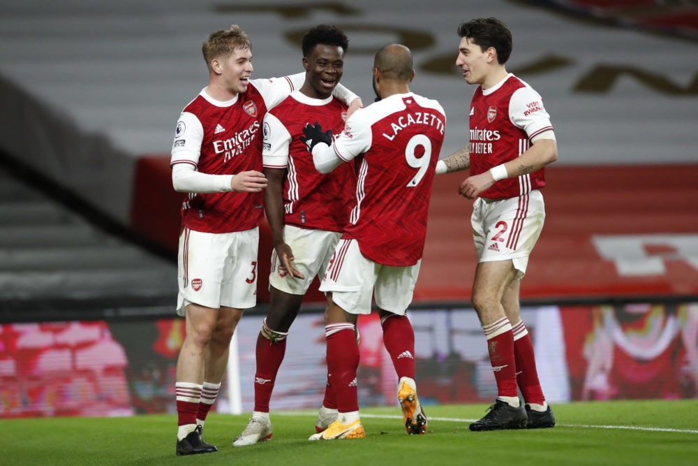 LONDON, ENGLAND - DECEMBER 26: Bukayo Saka of Arsenal celebrates with teammates Emile Smith Rowe, Alexandre Lacazette, and Hector Bellerin after sc...