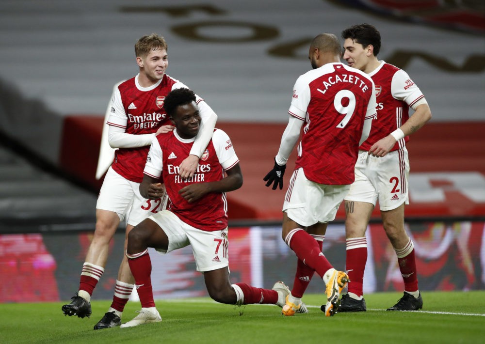 LONDON, ENGLAND - DECEMBER 26: Bukayo Saka of Arsenal celebrates with teammates Emile Smith Rowe, Alexandre Lacazette, and Hector Bellerin after scoring his team's third goal during the Premier League match between Arsenal and Chelsea at Emirates Stadium on December 26, 2020 in London, England. The match will be played without fans, behind closed doors as a Covid-19 precaution. (Photo by Andrew Boyers - Pool/Getty Images)