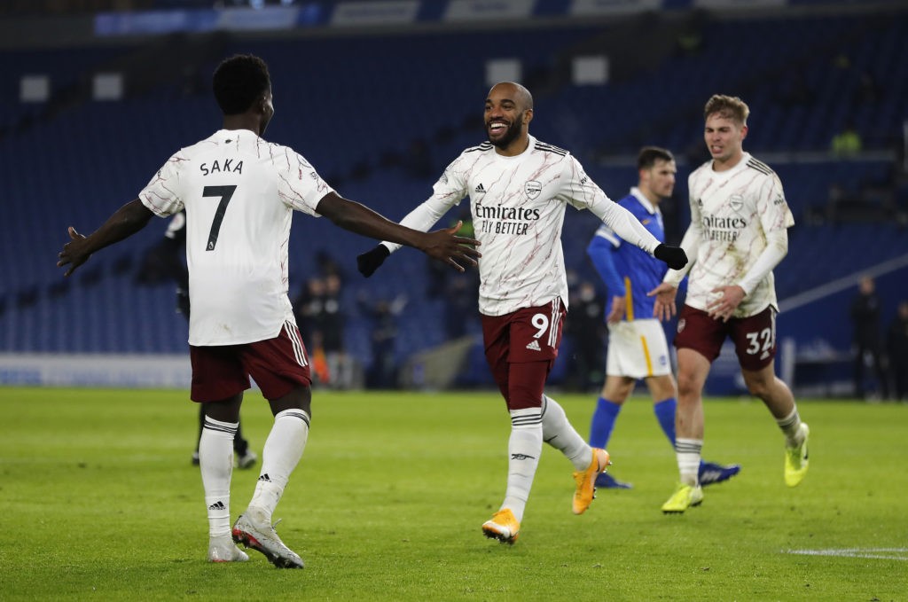 BRIGHTON, ENGLAND - DECEMBER 29: Alexandre Lacazette of Arsenal celebrates with teammate Bukayo Saka after scoring his team's first goal during the Premier League match between Brighton & Hove Albion and Arsenal at American Express Community Stadium on December 29, 2020 in Brighton, England. The match will be played without fans, behind closed doors as a Covid-19 precaution. (Photo by Frank Augstein - Pool/Getty Images)