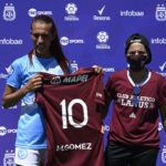 Argentine transgender footballer Mara Gomez (L) of Villa San Carlos poses with a jersey of Lanus with her name on it given as present after an Argentina first division female football match against Between Villa San Carlos and Lanus at Genacio Salice stadium in Berisso, Buenos Aires, Argentina on December 7, 2020. - Gomez is the first transgender footballer to play in the first division of the Argentine female league. (Photo by JUAN MABROMATA / AFP)
