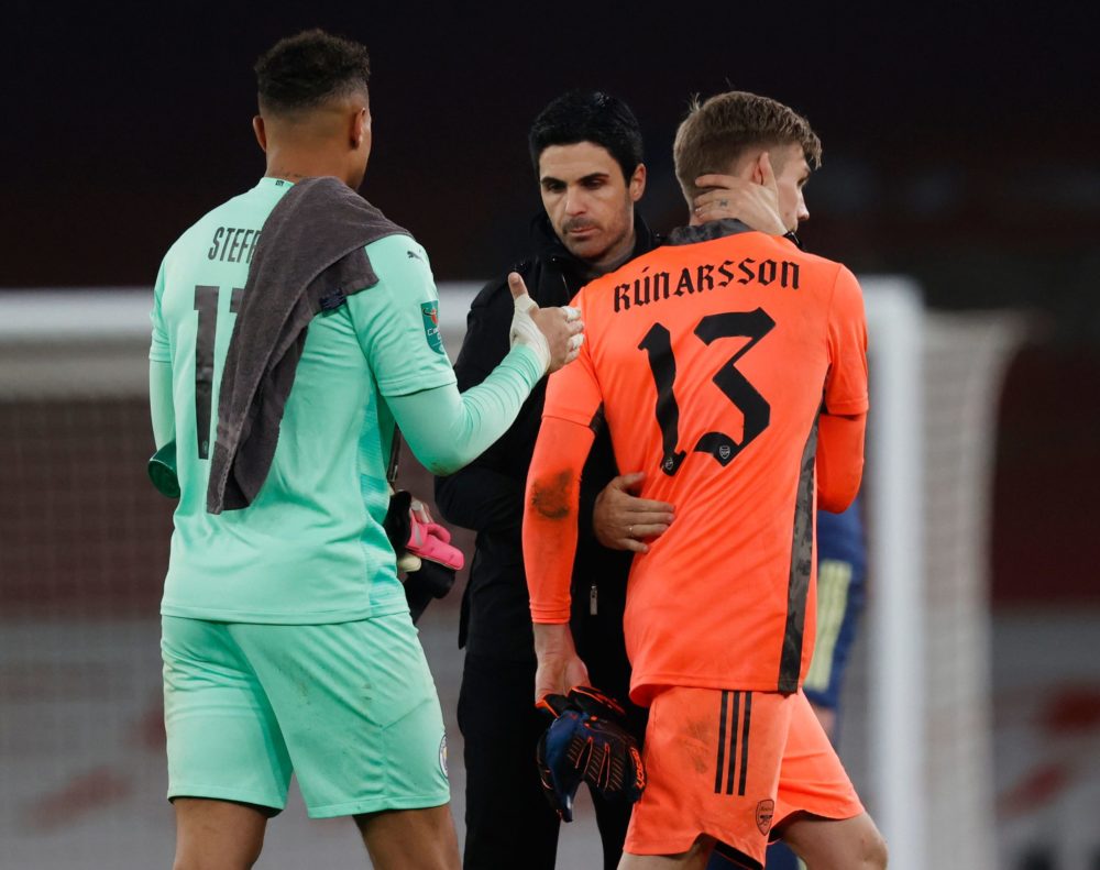 Arsenal's Spanish manager Mikel Arteta (C) consoles Arsenal's Icelandic goalkeeper Runar Alex Runarsson (R) after the English League Cup quarter final football match between Arsenal and Manchester City at the Emirates Stadium, in London on December 22, 2020. (Photo by Adrian DENNIS / AFP)