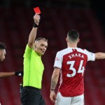 Referee Graham Scott shows the red card to send off Arsenal's Swiss midfielder Granit Xhaka (R) during the English Premier League football match between Arsenal and Burnley at the Emirates Stadium in London on December 13, 2020. (Photo by Laurence Griffiths / POOL / AFP)
