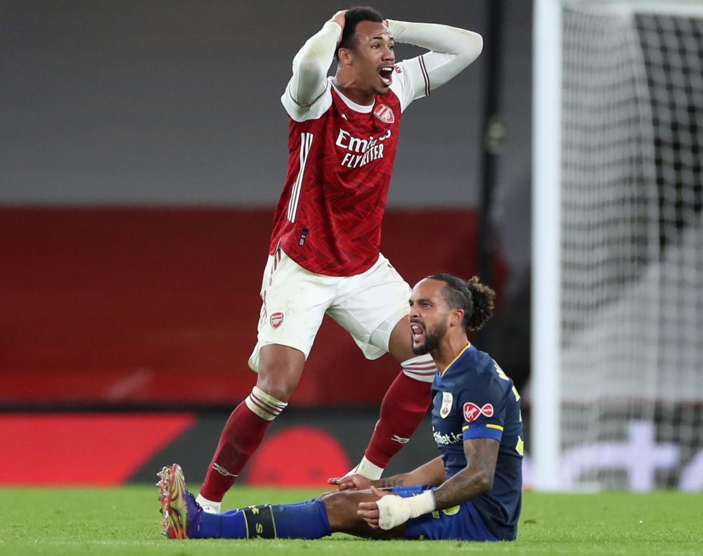 Arsenal's Brazilian defender Gabriel (L) reacts as he realises he is about to receive a red card from Referee Paul Tierney for his foul on Southamp...