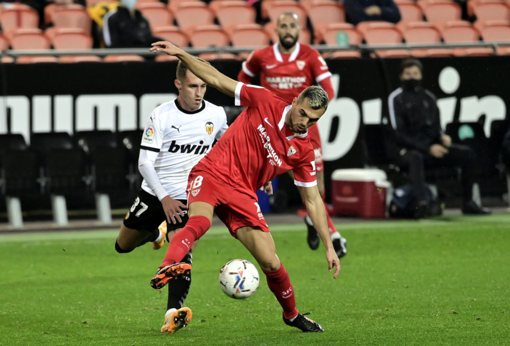 Valencia's Spanish midfielder Alex Blanco (L) challenges Sevilla's Spanish midfielder Joan Jordan during the Spanish league football match between ...