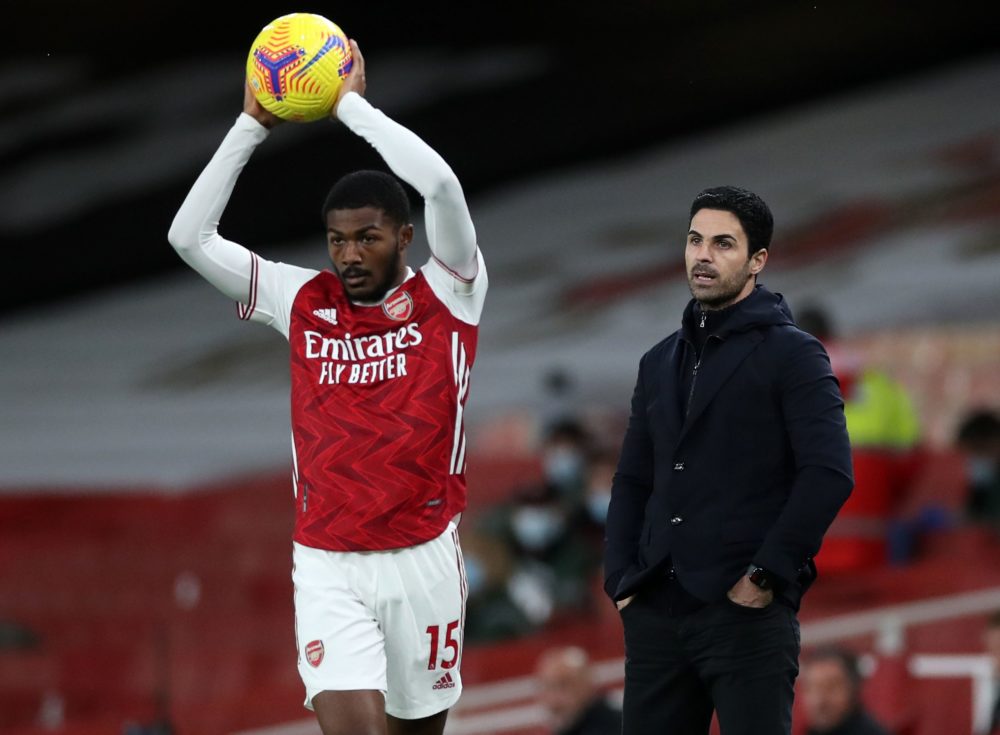 Arsenal's Spanish manager Mikel Arteta (R) watches as Arsenal's English midfielder Ainsley Maitland-Niles takes a throw in during the English Premi...