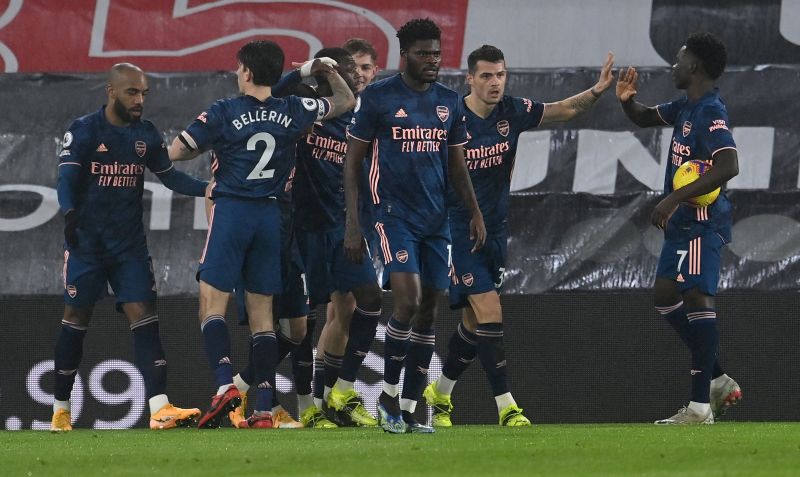 Arsenal's French-born Ivorian midfielder Nicolas Pepe (C) is mobbed by teammates after scoring the equalising goal during the English Premier League football match between Southampton and Arsenal at St Mary's Stadium in Southampton, southern England on January 26, 2021. (Photo by Andy Rain / POOL / AFP)