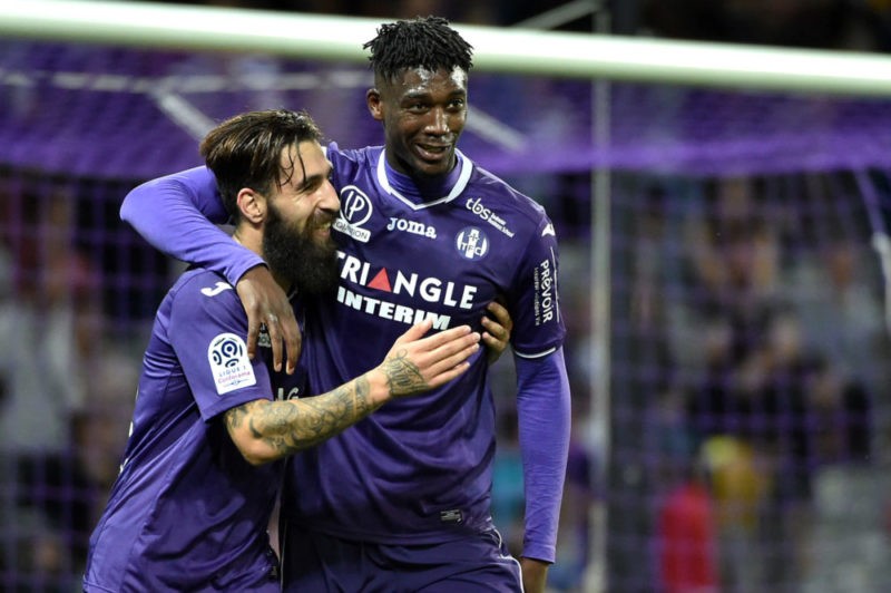 Toulouse's forward Yaya Sanogo (L) celebrates with teammate Jakup Durmaz after scoring his team's second goal during the French L1 football match b...