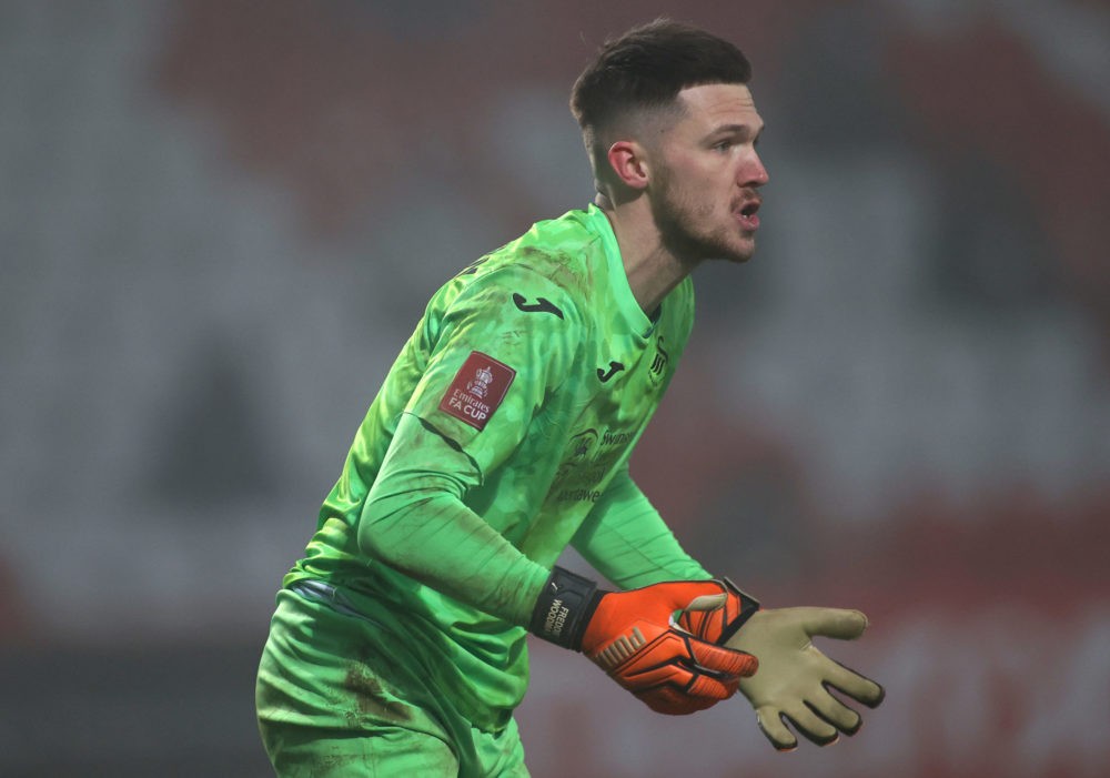 STEVENAGE, ENGLAND: Freddie Woodman of Swansea City looks on, where the Emirates FA Cup badge can be seen on his shirt sleeve during the FA Cup Thi...