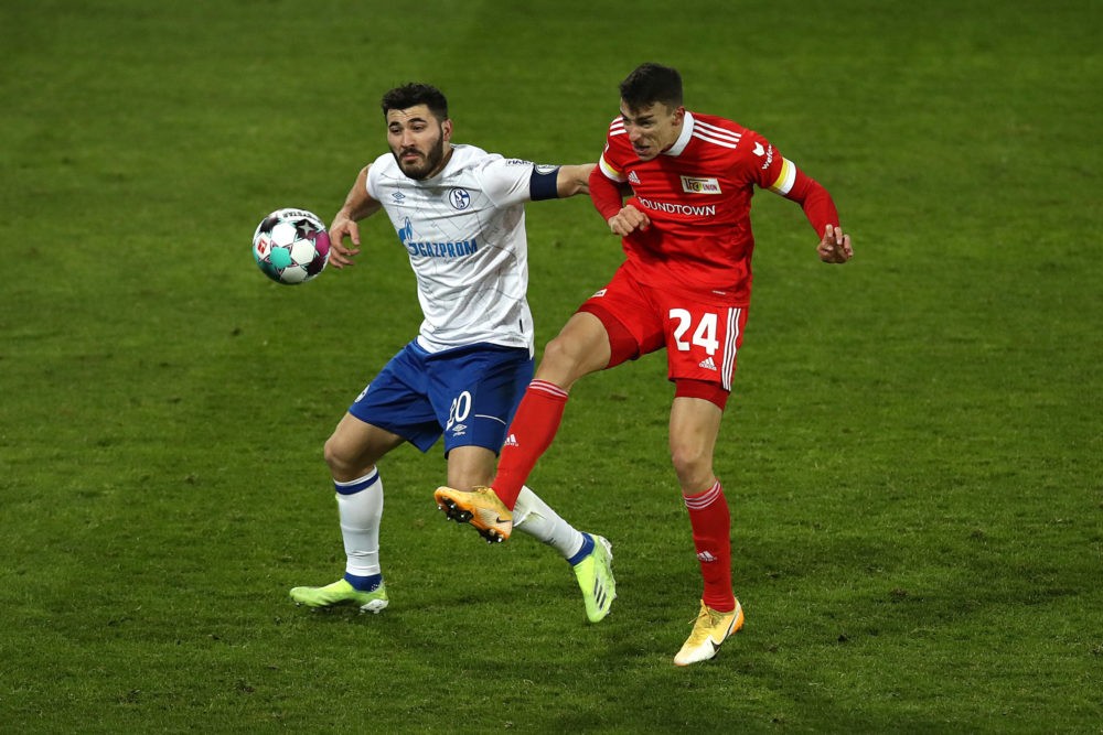 BERLIN, GERMANY: Sead Kolasinac of FC Schalke 04 battles for possession with Petar Musa of 1. FC Union Berlin during the Bundesliga match between 1...