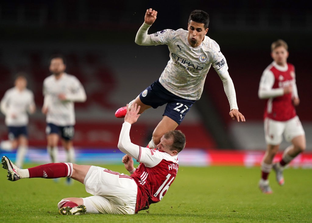 LONDON, ENGLAND: Joao Cancelo of Manchester City is tackled by Rob Holding of Arsenal during the Premier League match between Arsenal and Manchester City at Emirates Stadium on February 21, 2021. (Photo by John Walton - Pool/Getty Images)