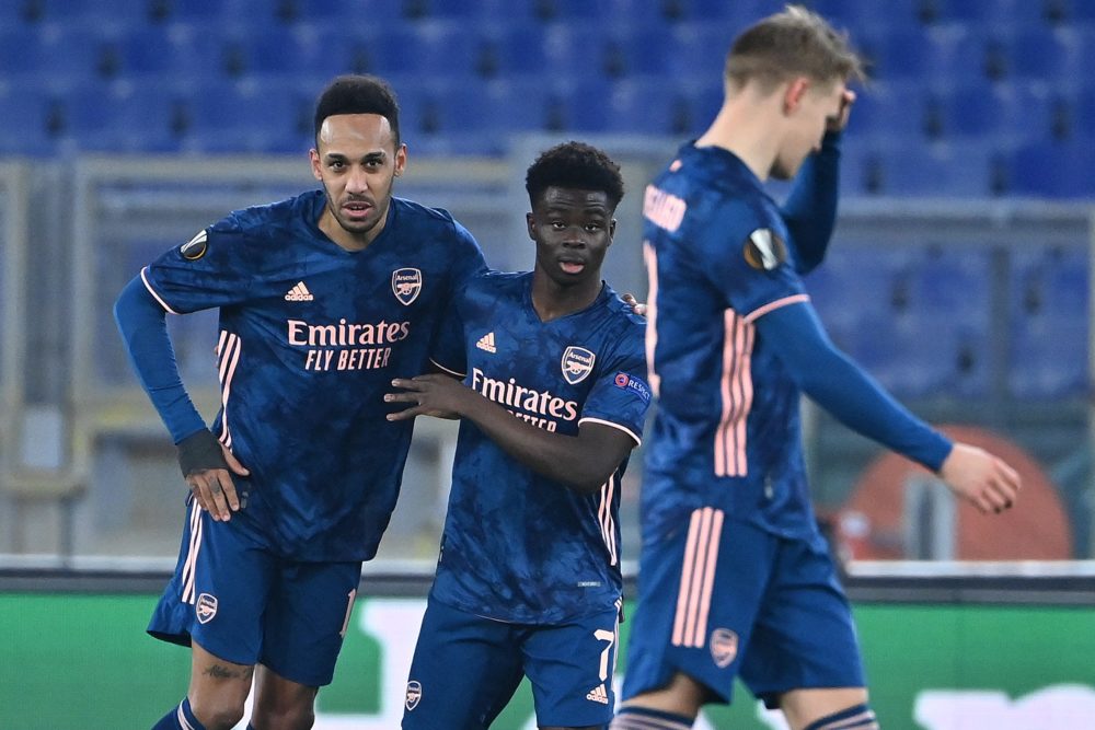 Arsenal's English striker Bukayo Saka (C) celebrates with Arsenal's Gabonese striker Pierre-Emerick Aubameyang after scoring a goal during the UEFA...