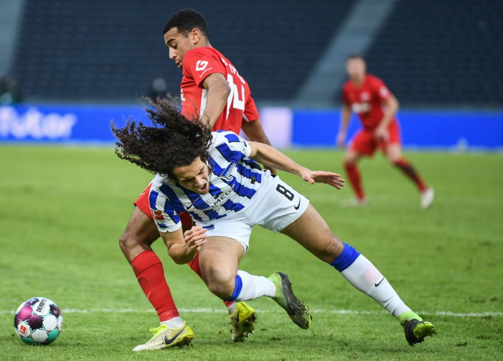 Leipzig's US midfielder Tyler Adams (Back) and Hertha Berlin's French midfielder Mattéo Guendouzi vie for the ball during the German first division...