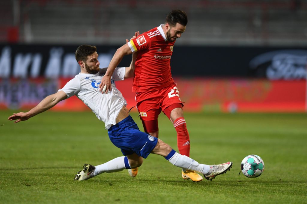 Schalke's German defender Shkodran Mustafi (L) and Union Berlin's German defender Niko Giesselmann vie for the ball during the German first division Bundesliga football match between 1 FC Union Berlin and FC Schalke 04 in Berlin on February 13, 2021. (Photo by ANNEGRET HILSE/POOL/AFP via Getty Images)