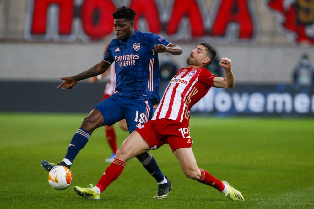 Thomas Partey of Arsenal battles for possession with Giorgos Masouras of Olympiacos during the UEFA Europa League match at Karaiskakis Stadium, Pir...