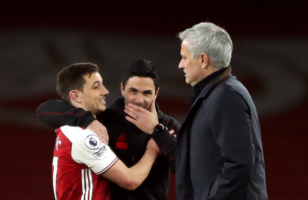 Arsenal v Tottenham Hotspur - Premier League - Emirates Stadium Arsenal manager Mikel Arteta and Cedric Soares celebrates as Tottenham Hotspur manager Jose Mourinho walks past after the final whistle during the Premier League match at Emirates Stadium, London. Picture date: Sunday March 14, 2021. Copyright: Nick Potts