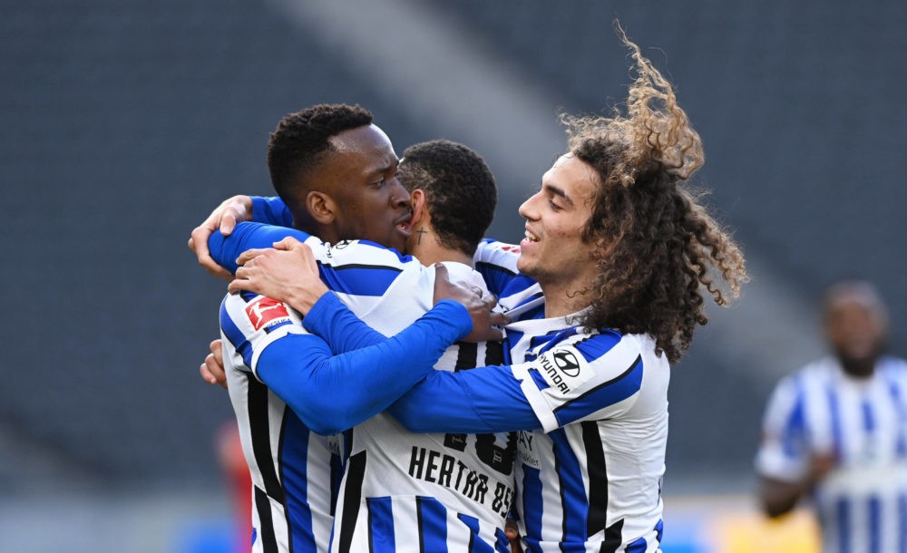 Matteo Guendouzi, Matheus Cunha, and Dodi Lukebakio celebrate a goal in the match between Hertha BSC and Bayer 04 Leverkusen, at the Olympiastadion...