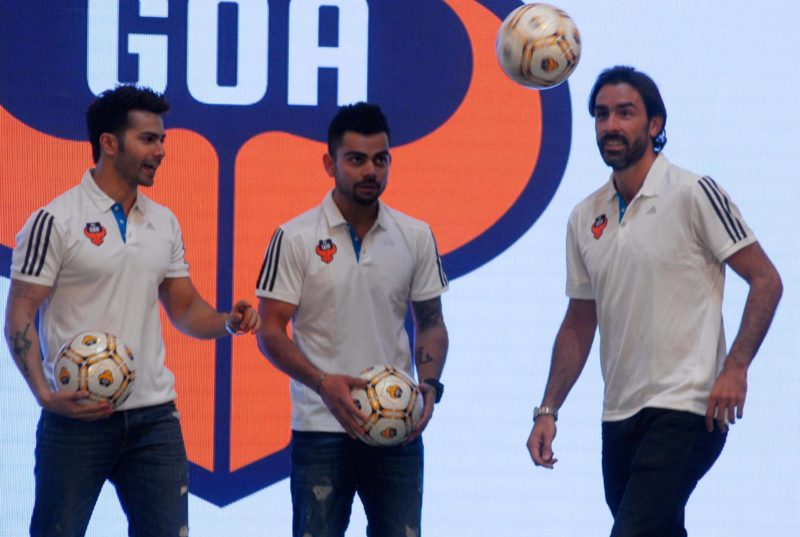 MUMBAI, INDIA - SEPTEMBER 23: (L- R) Bollywood actor Varun Dhawan with Co-owner of club and cricketer Virat Kohli and French footballer and marquee player Robert Pires during a press conference PK Pressekonferenz on September 23, 2014 in Mumbai, India. (Photo by Prodip Guha/Hindustan Times Virat Kohli And Varun Dhawan With Robert Pires At FC Goa Jersey Launch