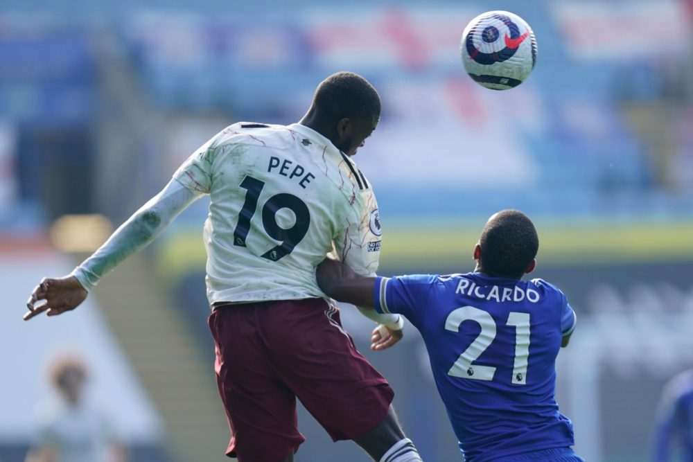 Arsenal's French-born Ivorian midfielder Nicolas Pepe (L) vies with Leicester City's Portuguese defender Ricardo Pereira (R) during the English Pre...