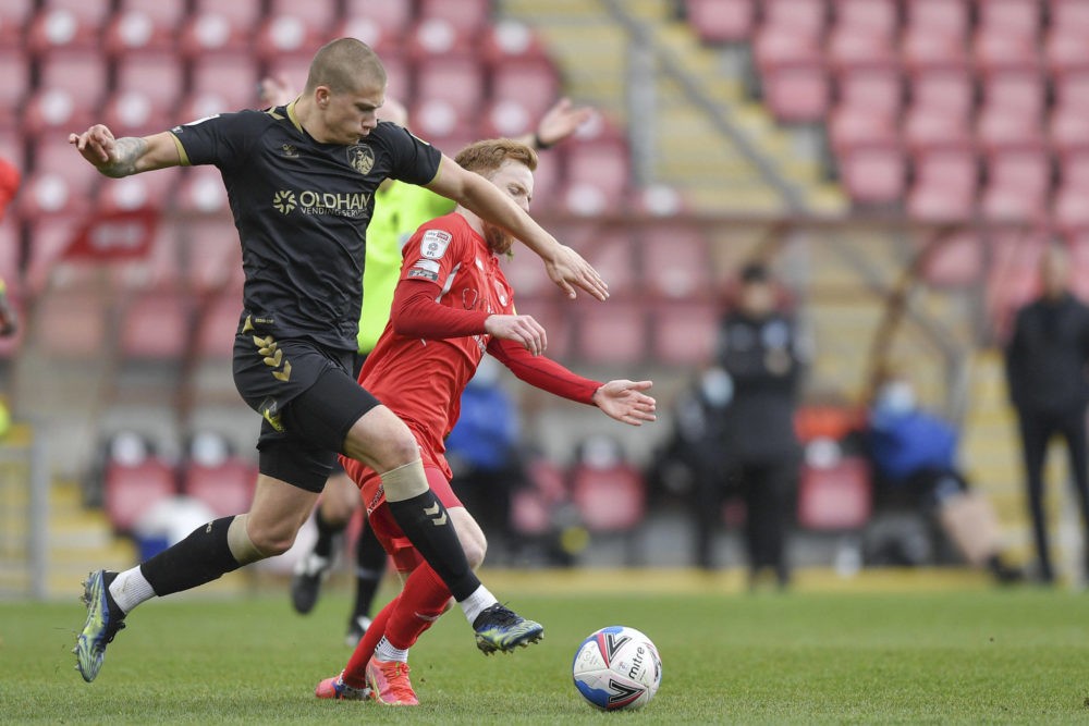 Harry Clarke of Oldham Athletic battles with James Brophy of Leyton Orient during the Sky Bet Championship behind closed doors match between Millwa...