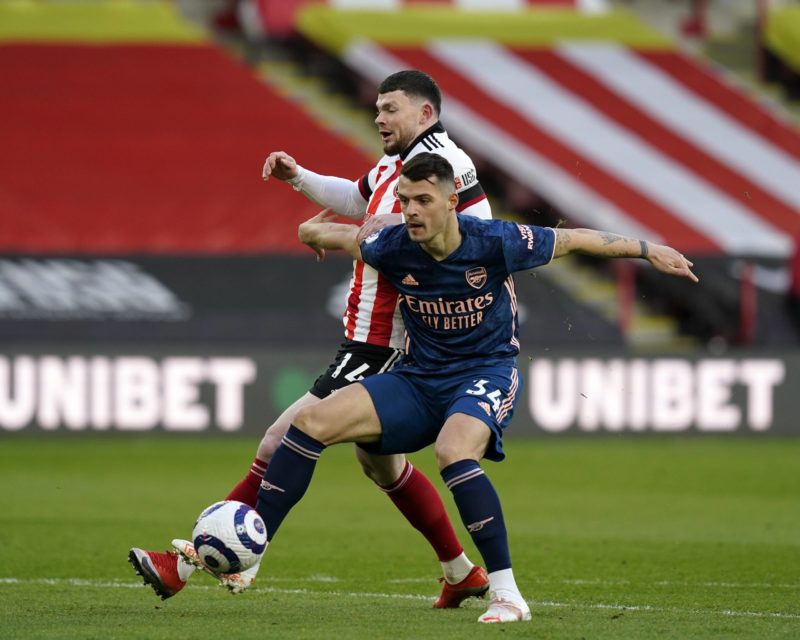 Sheffield, England, 11th April 2021. Oliver Burke of Sheffield Utd tussles with Granit Xhaka of Arsenal during the Premier League match at Bramall ...
