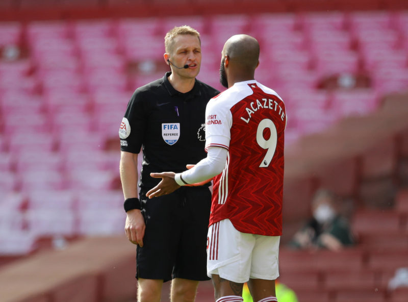 London, England, 18th April 2021. Referee Craig Pawson talks to Alexandre Lacazette of Arsenal during the Premier League match at the Emirates Stad...