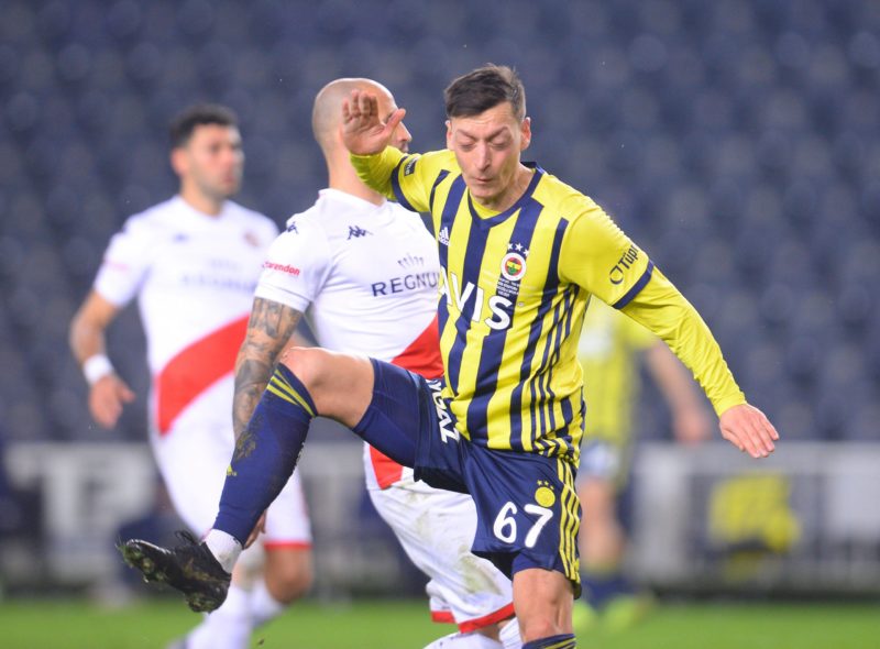 Mesut Ozil of Fenerbahce and Fedor Kudryashov of Antalyaspor during the Turkish Super League football match between Fenerbahce and Antalyaspor at U...