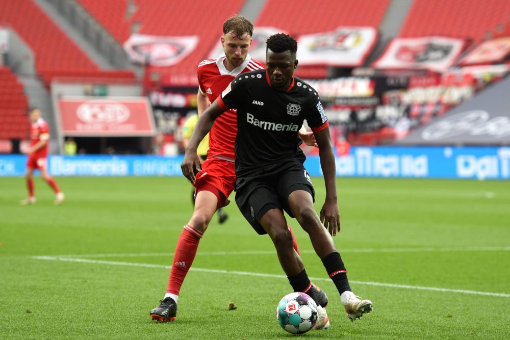Berlin's Marcus Ingvartsen and Leverkusen's Edmond Tapsoba compete for the ball on 15/05/2021 at BayArena in Leverkusen. Copyright: Christopher Neu...