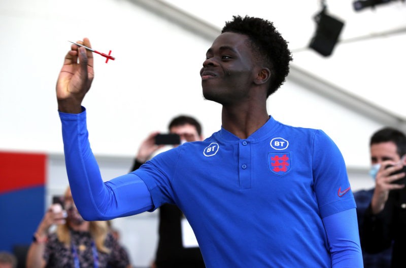 England's Bukayo Saka plays darts with media following the press conference at St George s Park, Burton upon Trent. Copyright: Nick Potts