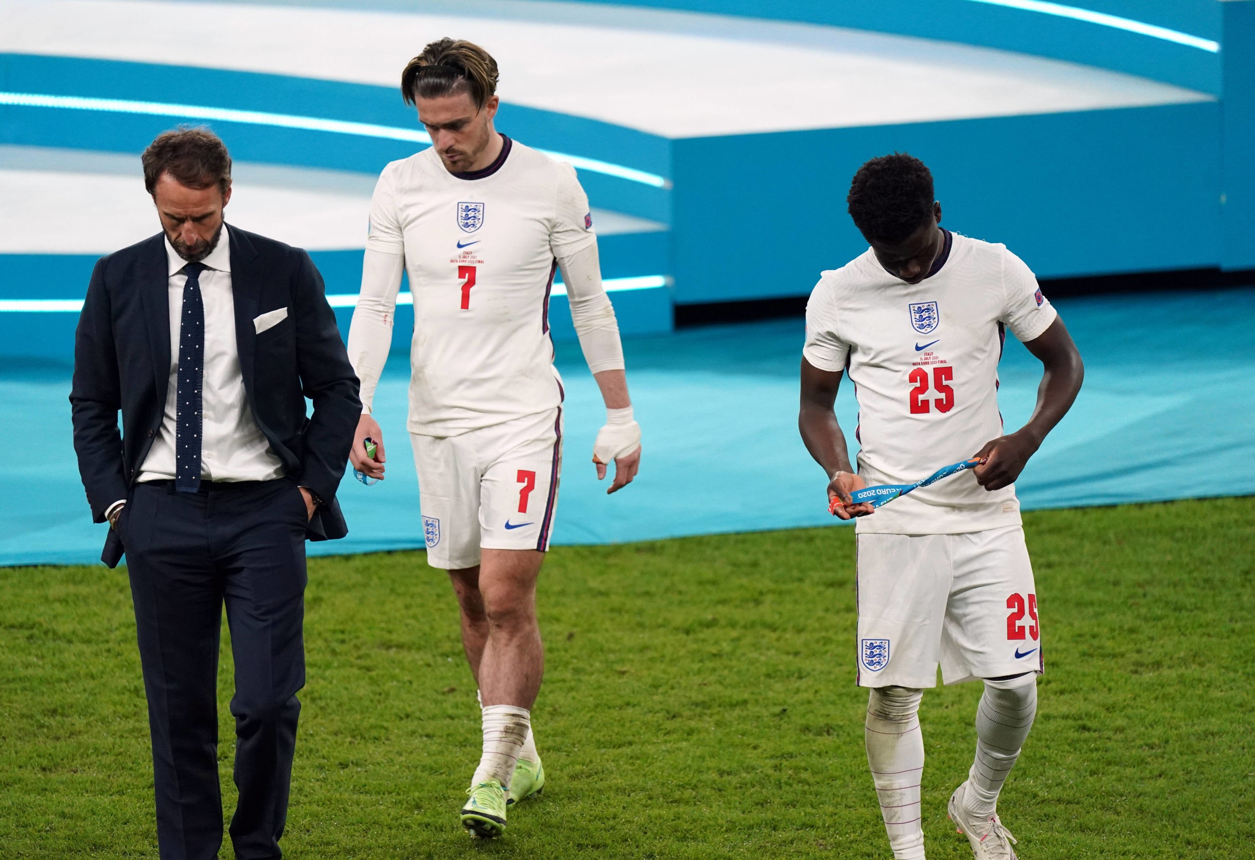 Italy v England - UEFA EURO 2020 Final - Gareth Southgate stands dejected alongside Bukayo Saka and Jack Grealish following the UEFA Euro 2020 Fina...