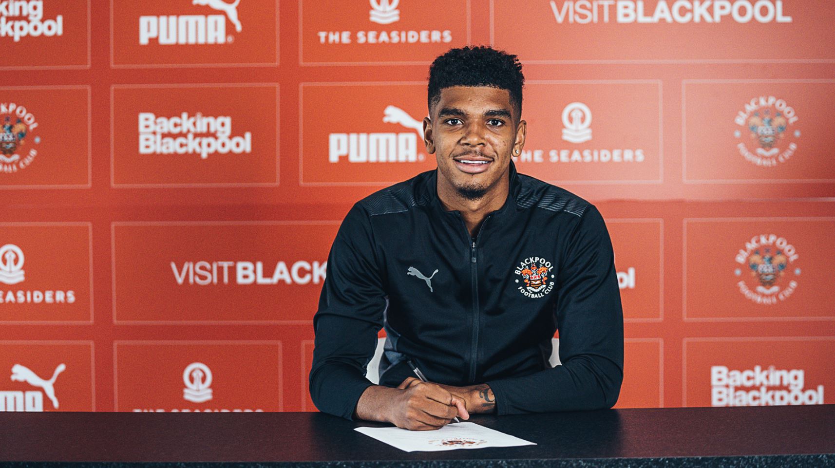 Tyreece John-Jules signing for Blackpool (Photo via BlackpoolFC.co.uk)