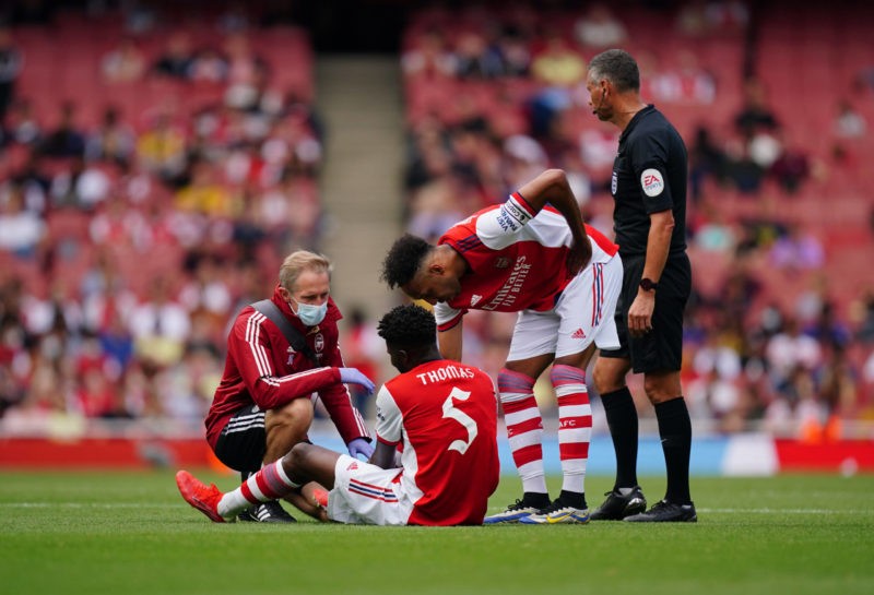 Emirates Stadium Arsenal s Thomas Partey centre receives treatment on the pitch during The Mind Series match at Emirates Stadium, London. Picture d...