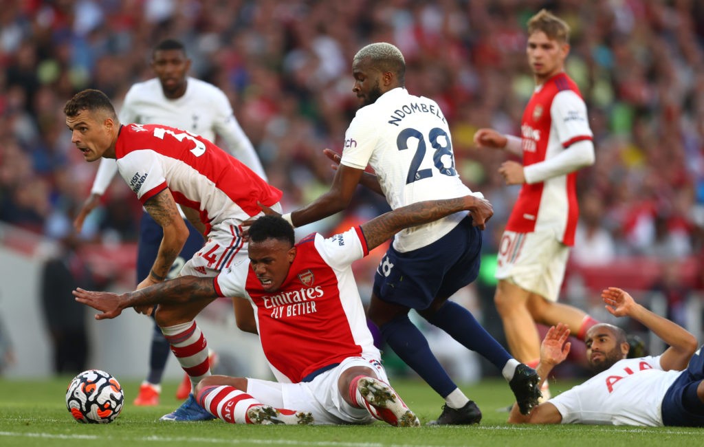 LONDON, ENGLAND - SEPTEMBER 26: Tanguy Ndombele of Tottenham Hotspur battles for possession with Granit Xhaka and Gabriel Magalhaes of Arsenal during the Premier League match between Arsenal and Tottenham Hotspur at Emirates Stadium on September 26, 2021 in London, England. (Photo by Clive Rose/Getty Images)