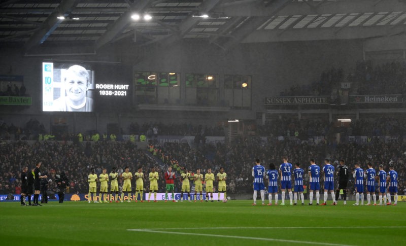 BRIGHTON, ENGLAND - OCTOBER 02: Both teams and fans stand for a minute of applause in memory of former footballer, Roger Hunt who recently passed away prior to the Premier League match between Brighton & Hove Albion and Arsenal at American Express Community Stadium on October 02, 2021 in Brighton, England. (Photo by Mike Hewitt/Getty Images)