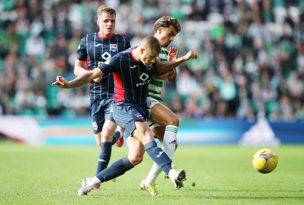 GLASGOW, SCOTLAND: Harry Clarke of Ross County vies with Jota of Celtic during the Cinch Scottish Premiership match between Celtic FC and Ross Coun...